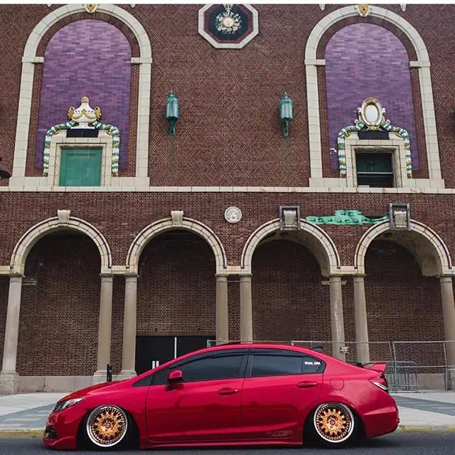 Red Honda Civic in front of brick arches