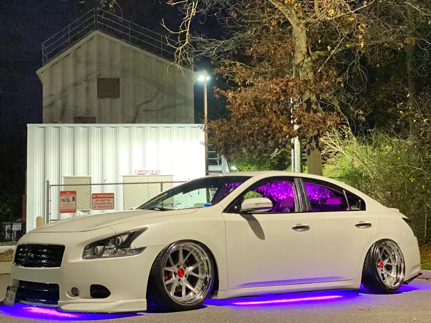 White Nissan Maxima with purple underglow